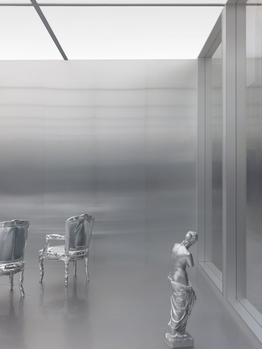 silver statue and chairs in a silver room