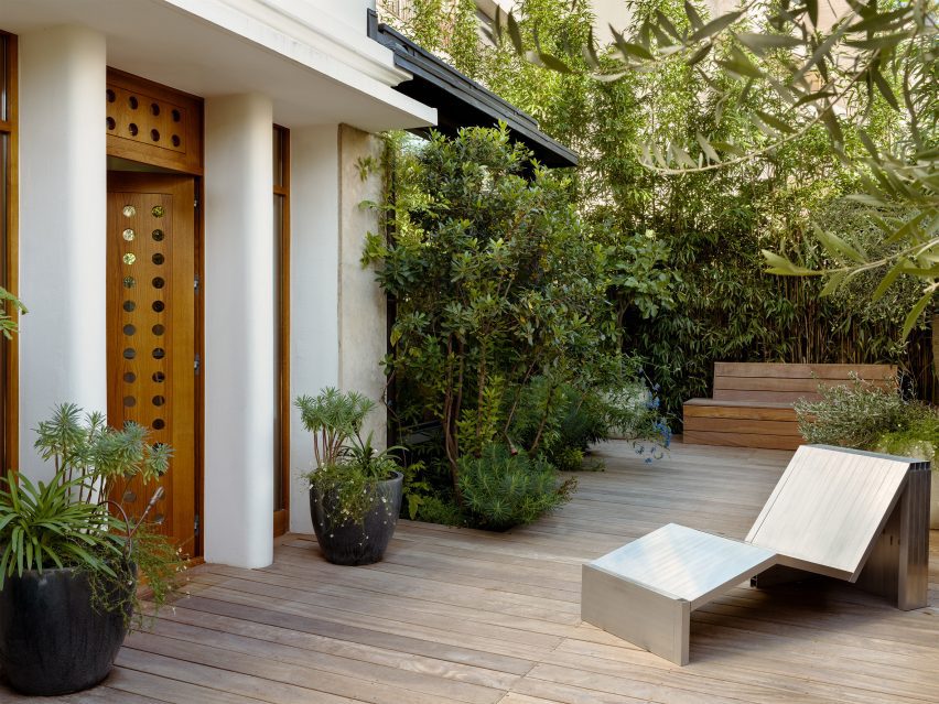 wooden front door of the home in paris, designed by hauvette & madani