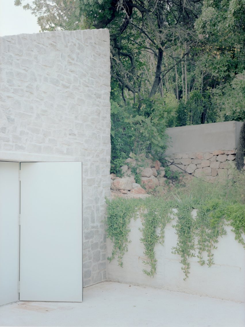 stone-clad exterior of home by argu studio