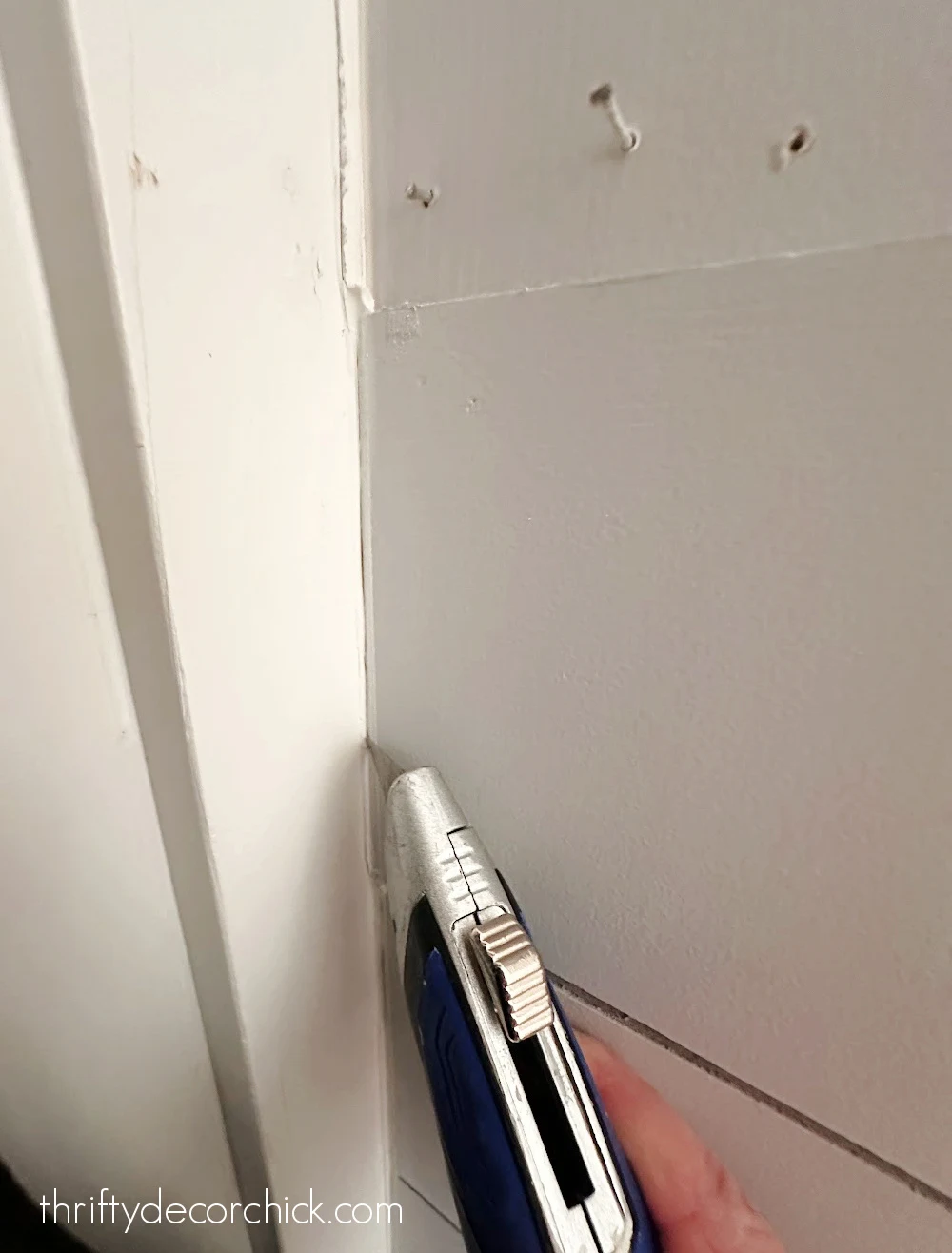 scoring caulk with razor blade