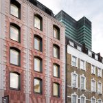 Bureau de Change enlivens apartment block with pink panels