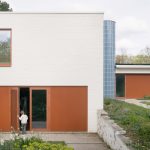 Felt updates midc-entury bungalow in Ghent with blue-tiled tower