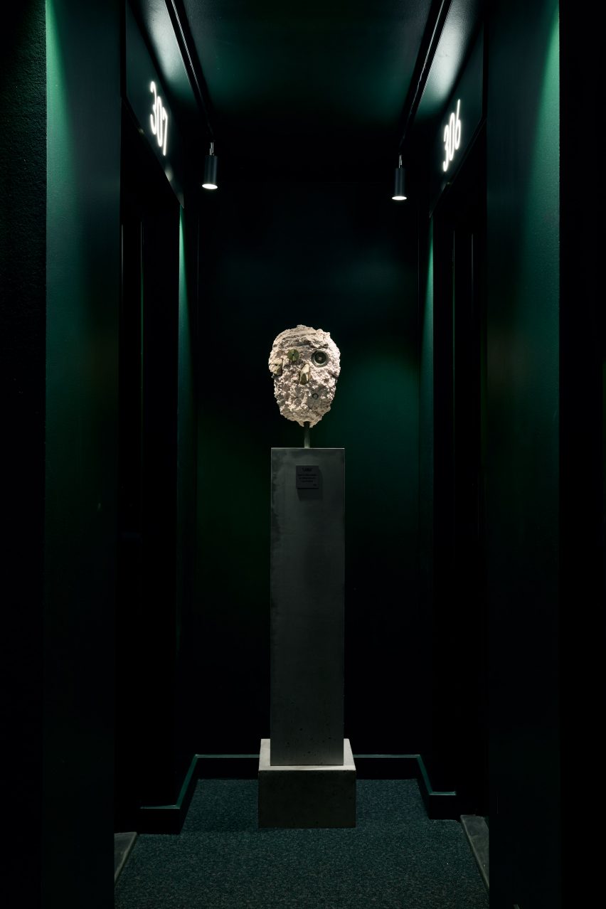 white sculpture in green corridor