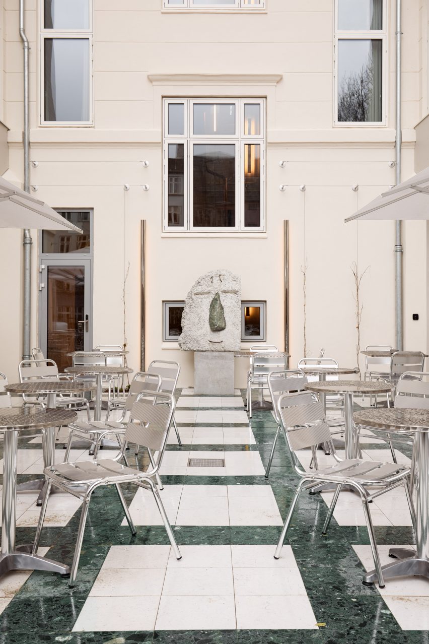 courtyard with sculpture of smiling face