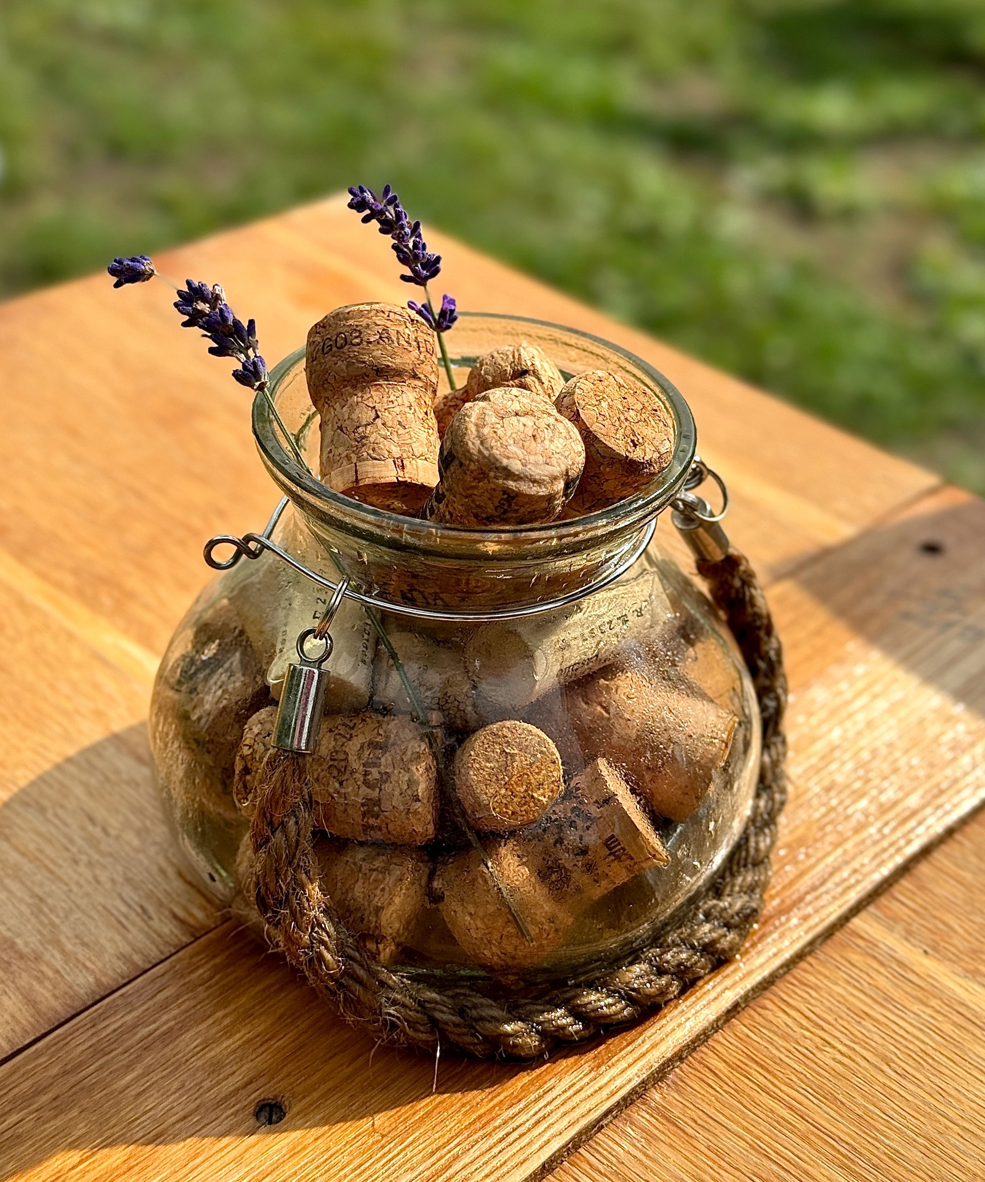 glass jar of wine corks on garden table