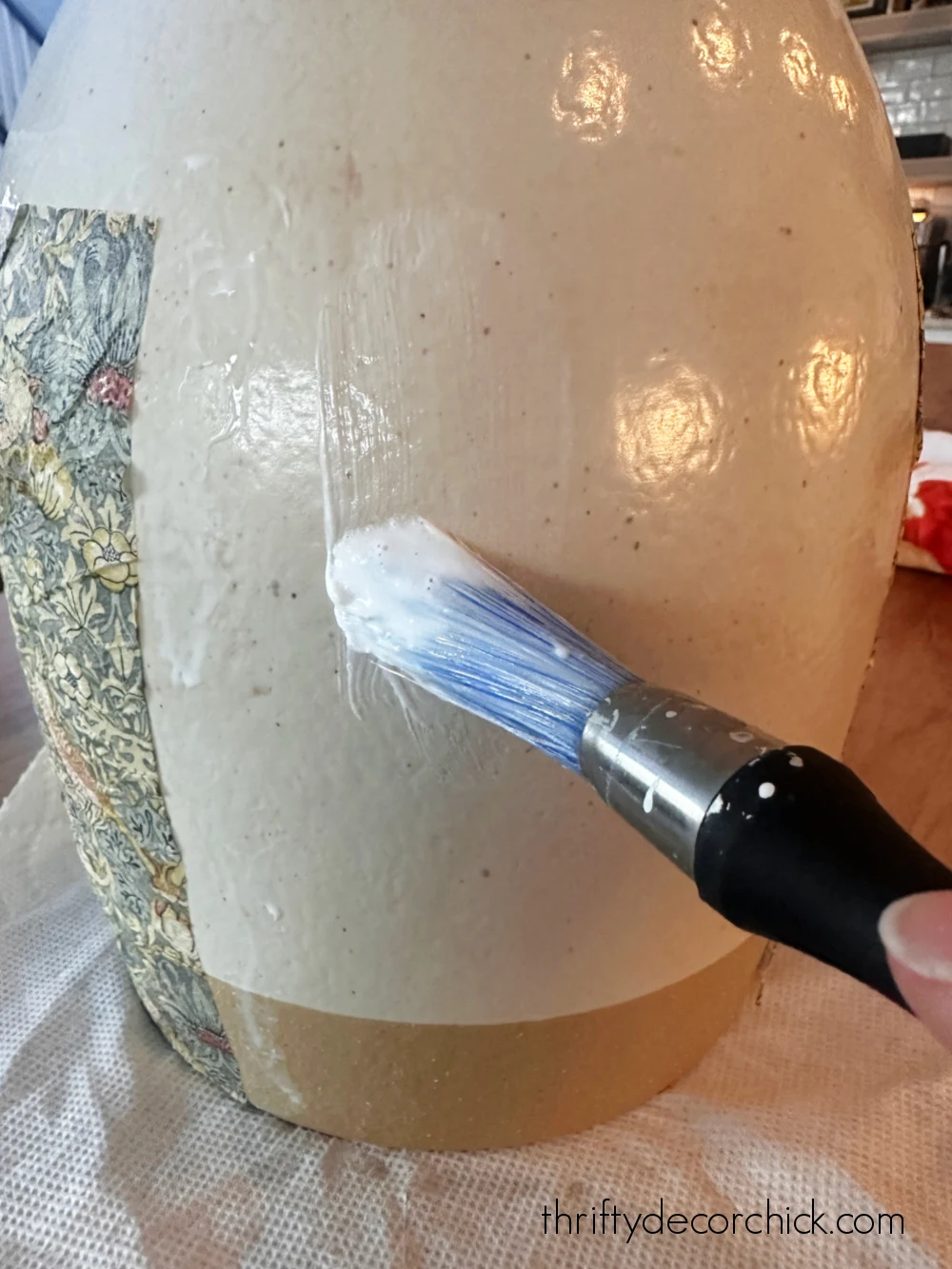 gluing paper onto vase
