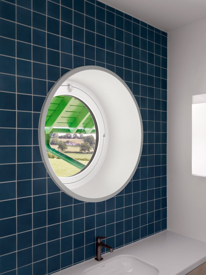 porthole window in red house by david kohn architects