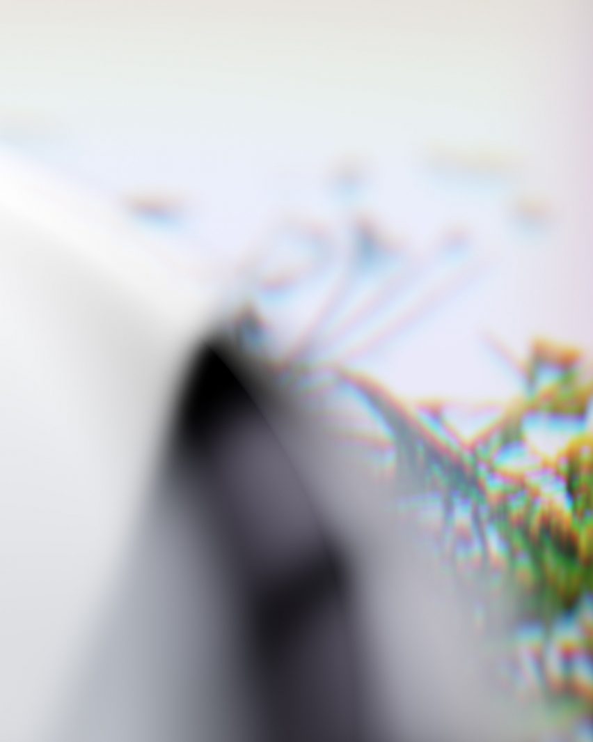 Blurry image of the Cognitive Bloom showing chrome hardware and an image of leaves and blooms