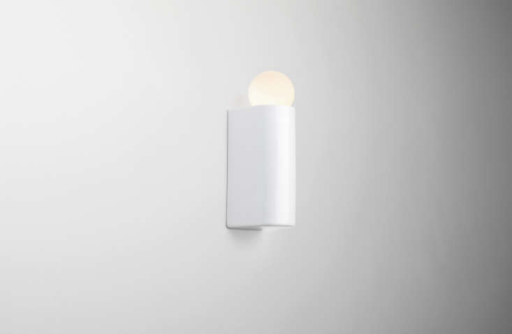 the mirror is flanked by porcelain series wall lights by michael anastassiades. 22