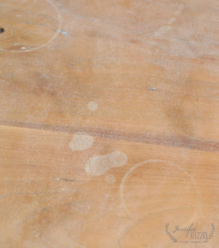 Remove Water Rings From Wood Furniture 1 A wooden surface with visible water stains and rings from furniture.