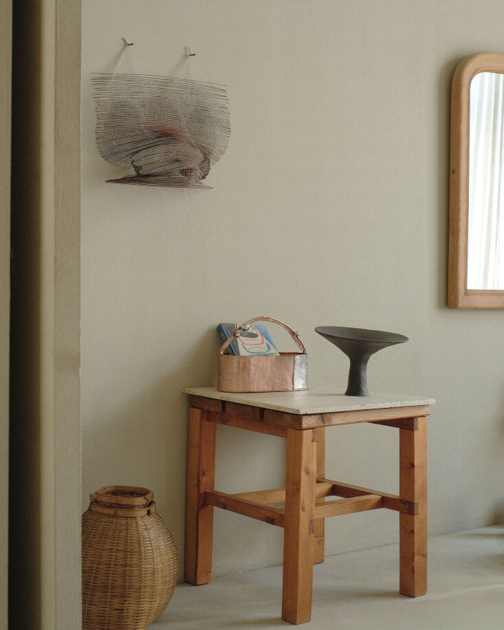 on a bench sits the stoneware raised vessel iii by kasia herself, available thr 19