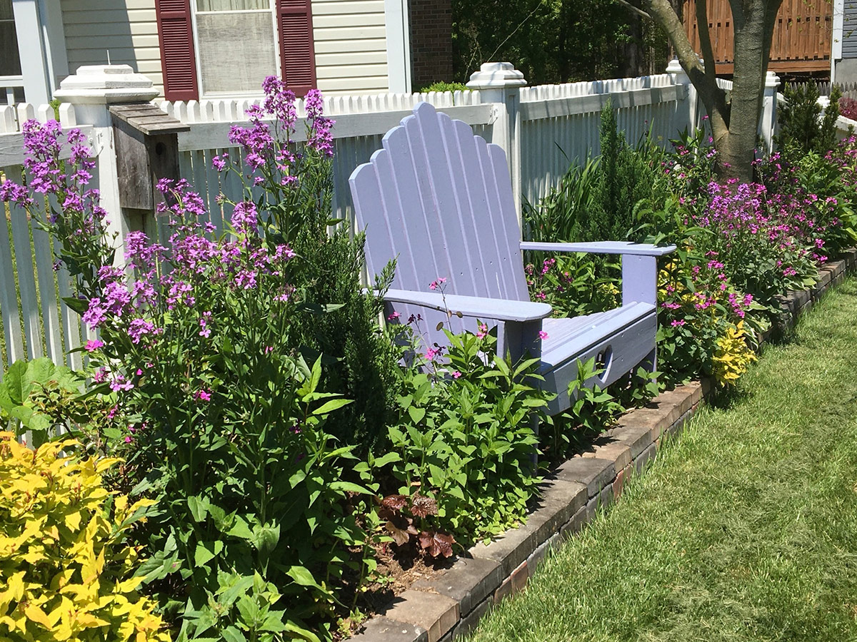 adirondack chair in garden border 