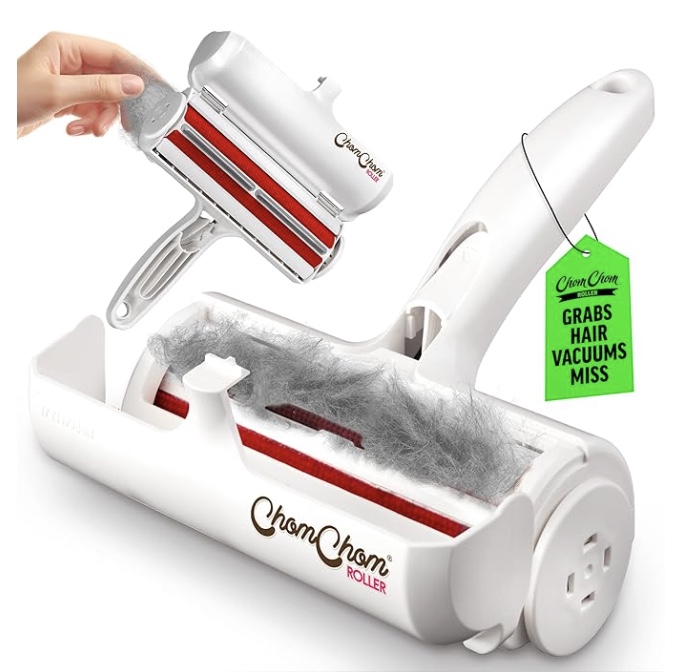 a hand uses a white and red chomchom roller to collect pet hair, visible inside the roller. a green tag reads, "grabs hair, vacuums miss." perfect for cleaning tips for the house, this tool keeps surfaces spotless.