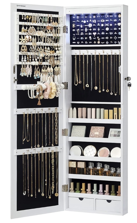 a white jewelry cabinet with an open door displays organized earrings, necklaces, bracelets, rings, cosmetics, and perfume bottles. small drawers and compartments store additional accessories and makeup items.