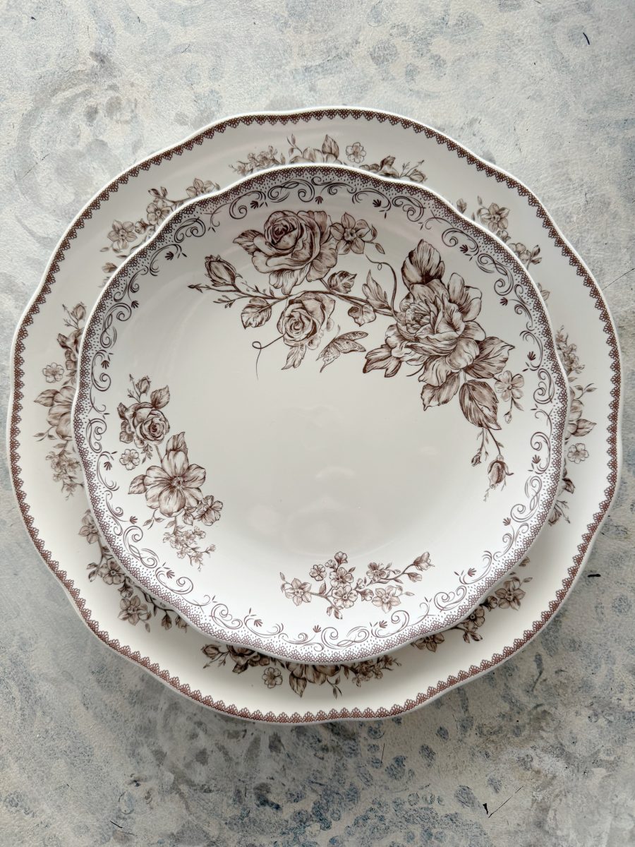 7 simple steps to style a hutch 30 two vintage-style plates with brown floral patterns are stacked on a light, textured surface. perfect to style a hutch, the top plate is smaller and round, both featuring intricate rose designs along the edges.