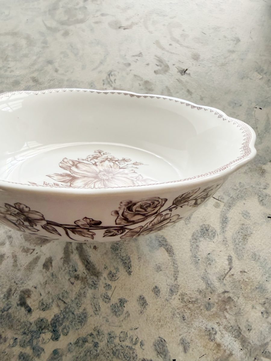 7 simple steps to style a hutch 32 a white ceramic bowl with scalloped edges and brown floral patterns sits on a light, textured surface—perfect to style a hutch with its subtle, artistic charm.