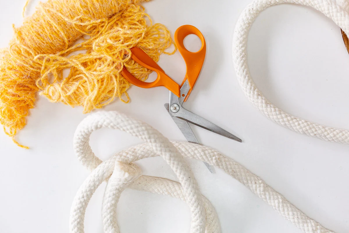 craft supplies to make an easter basket - yarn, cording, and scissors