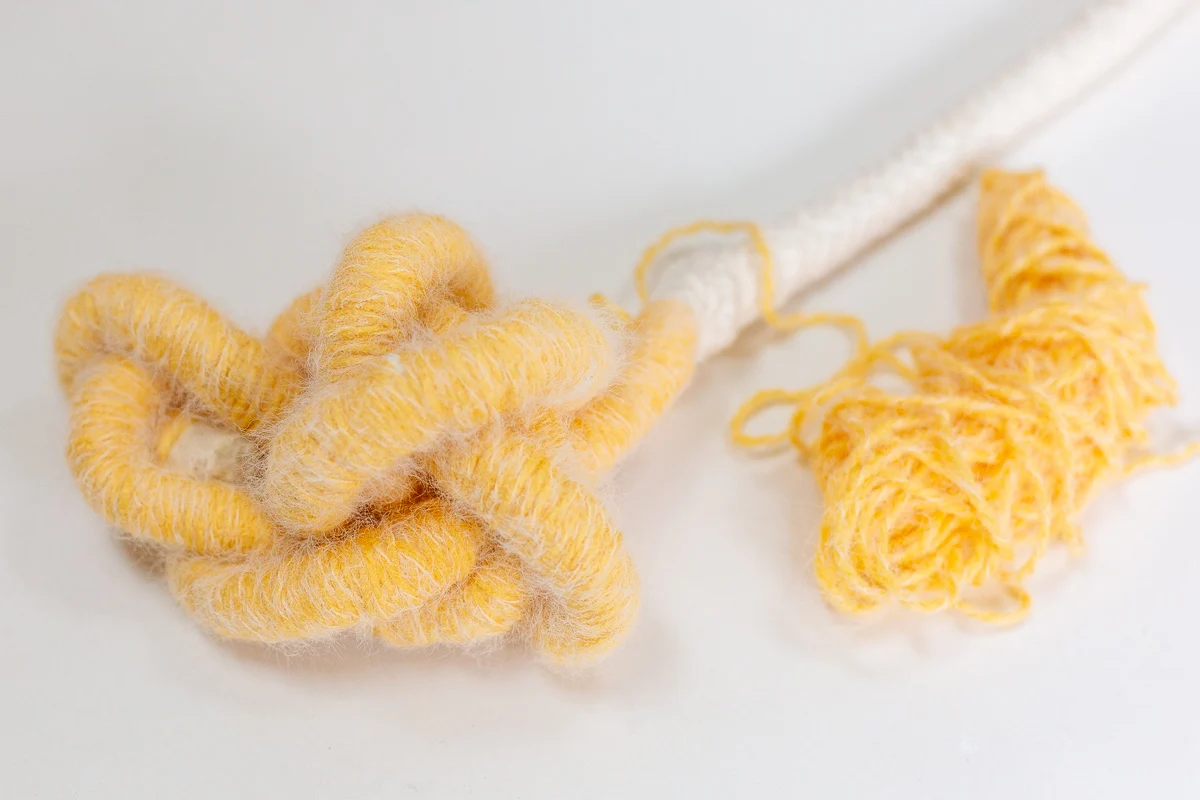 yellow yard wrapped around cotton cording to make thick cording for a basket