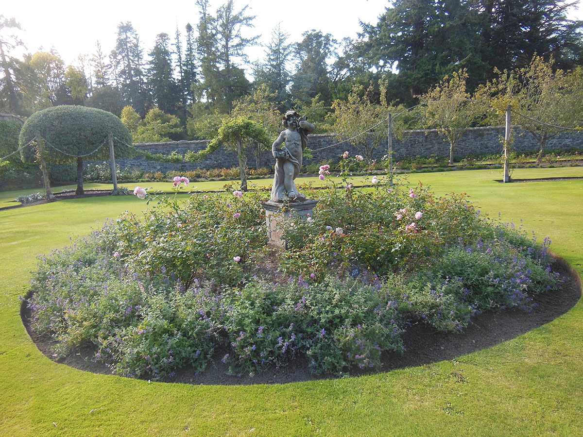 circular garden bed with statue in the middle