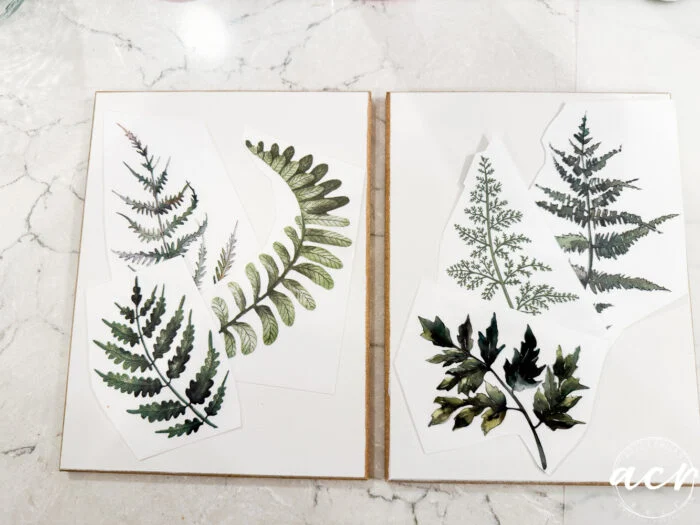 two open sketchbooks display botanical illustrations of different fern leaves on white paper, all resting on a white marble surface. this easter edition artwork features a variety of green leaf shapes and textures in delightful flipping smalls style.