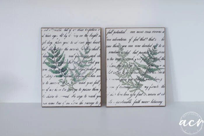 two botanical wall art prints side by side, each featuring green fern illustrations overlaid on a background of cursive script, displayed on a plain white surface—a charming easter edition from flipping smalls.