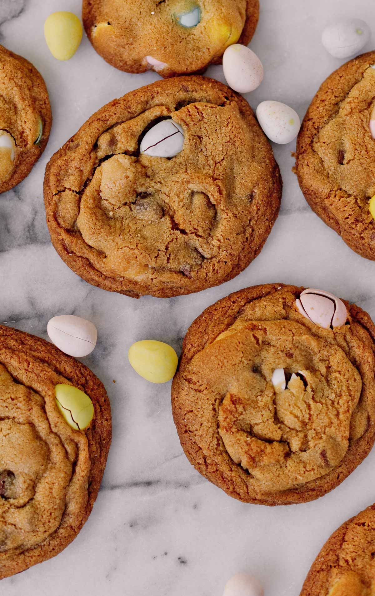 closeup details of cookies on marble slab with cadbury candy surrounding it