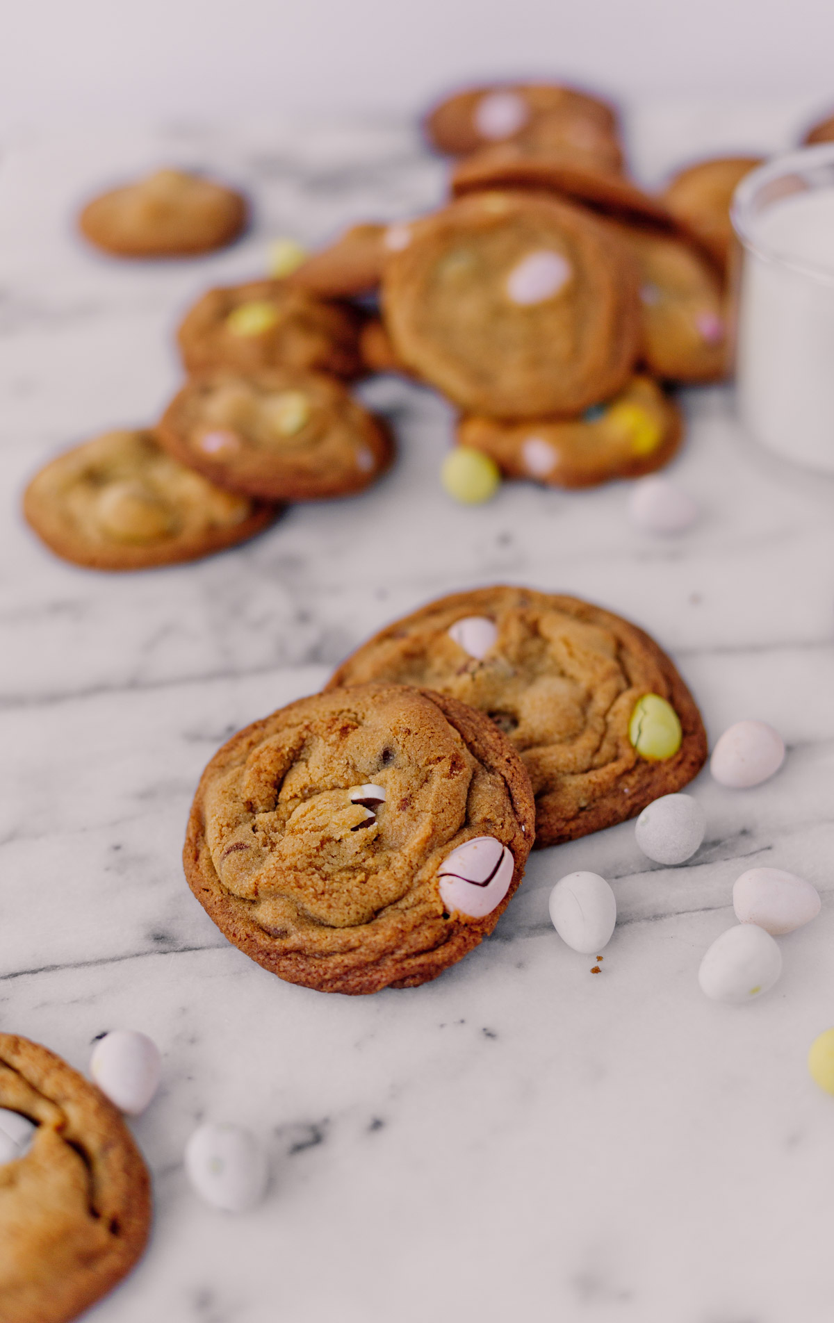 cadbury choc chip cookies on marble with easter candy all around 