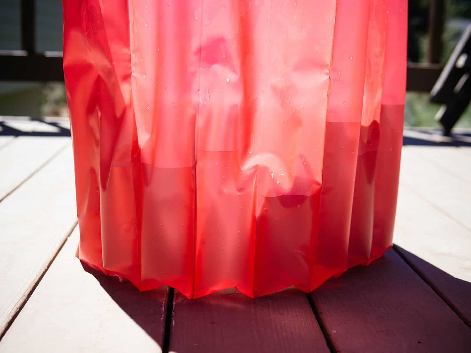 tubes on a red tomato teepee partially filled with water
