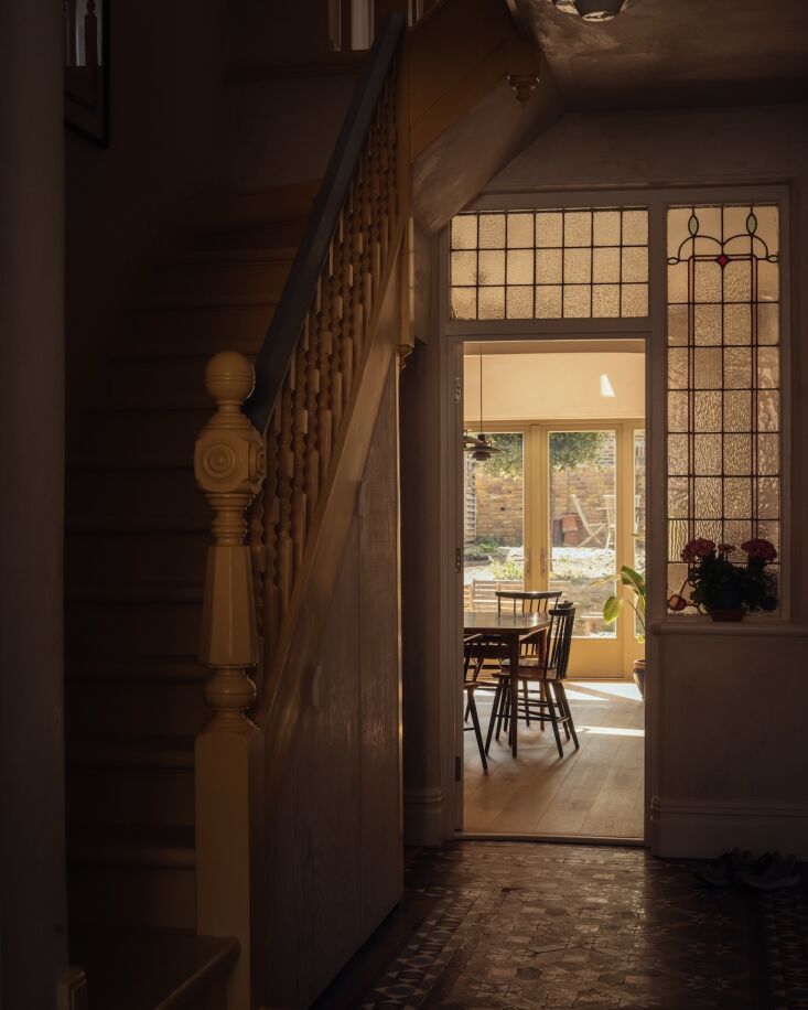 the front hall, with preserved stair and stained glass, overlooks the extension. 20