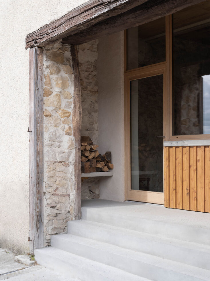 oak framed windows and front entry with an integrated concrete shelf for wood s 18