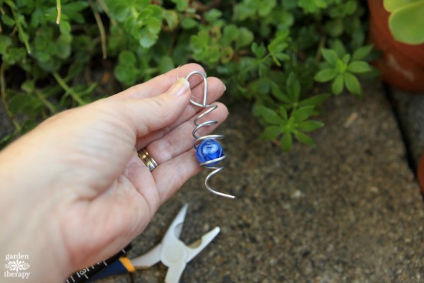 add the marble into the wire coil