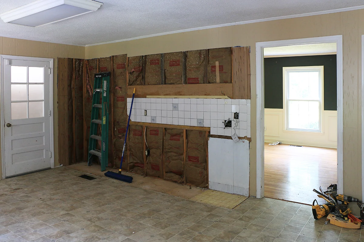 room being renovated: kitchen cabinets ripped out.