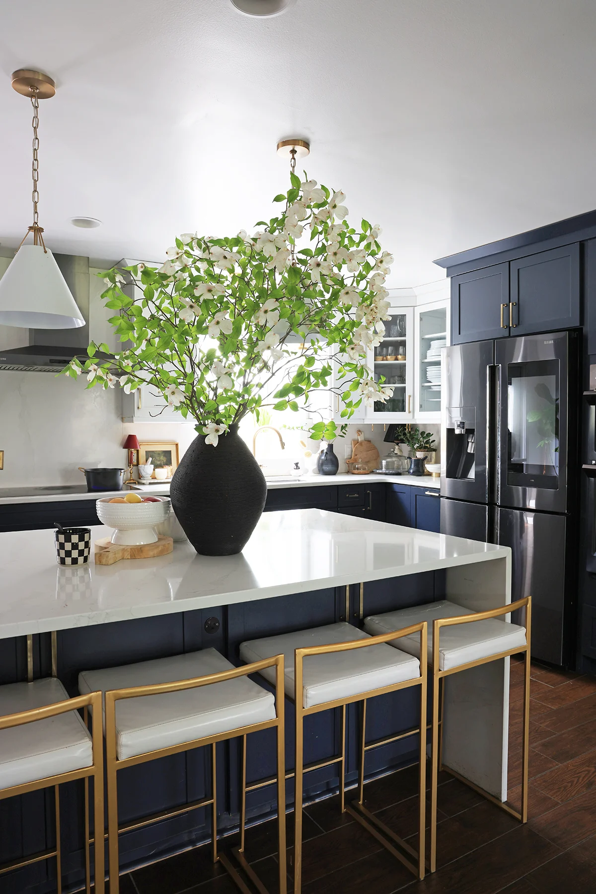 kitchen with large bouquet of dogwoods in a case
