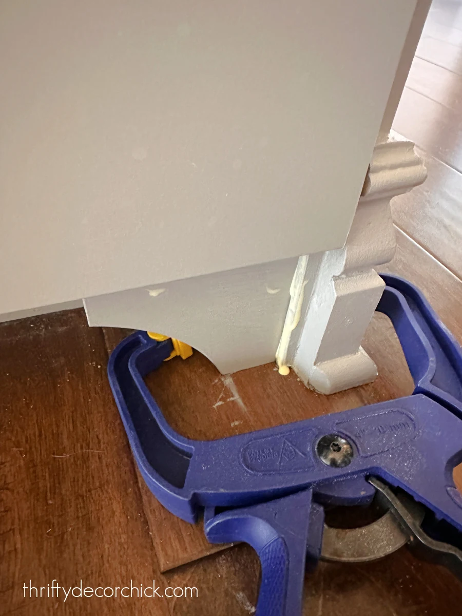 how to update basic cabinets with diy furniture feet | thrifty decor chick 12 gluing cabinet feet toe kick