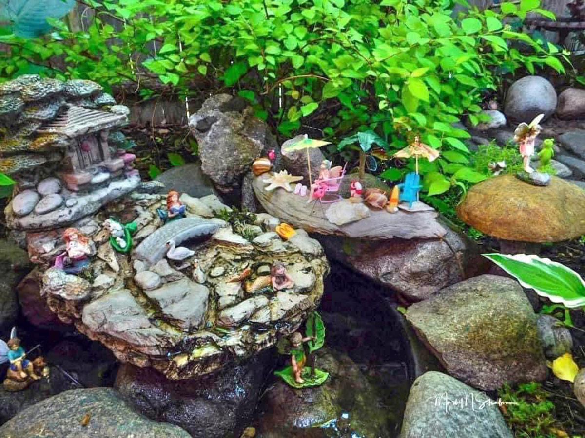mini fairy figurines in a garden