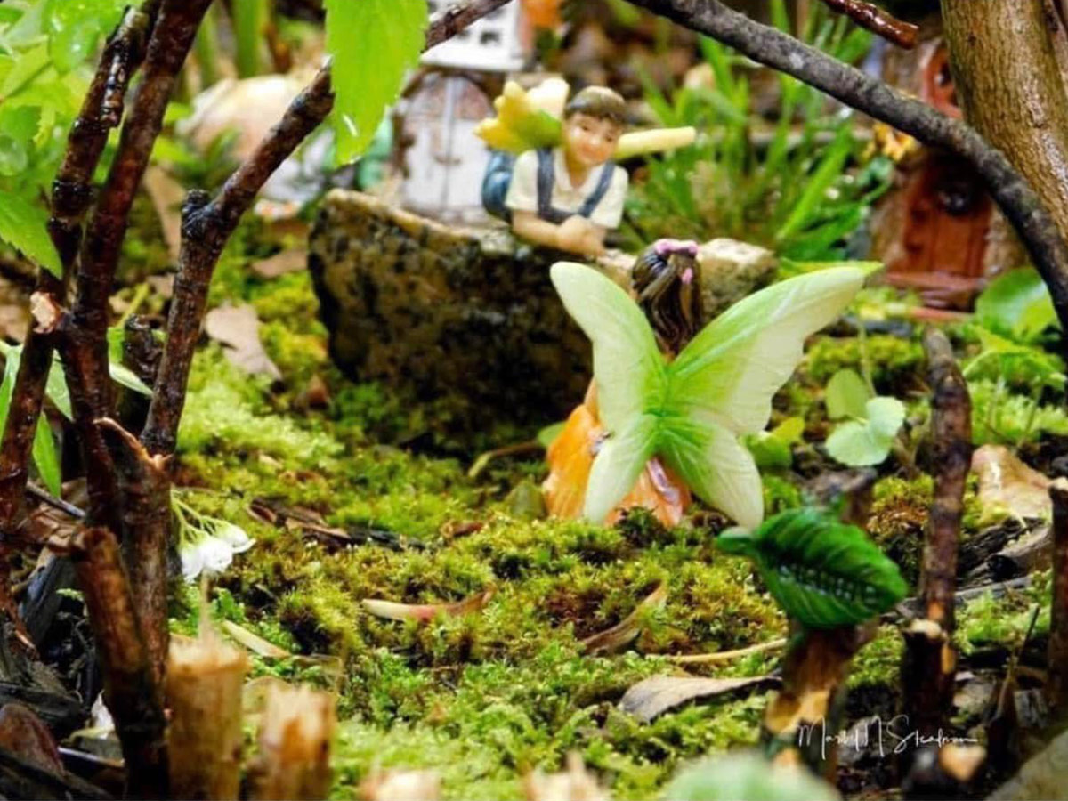 mini fairy figurines in a garden