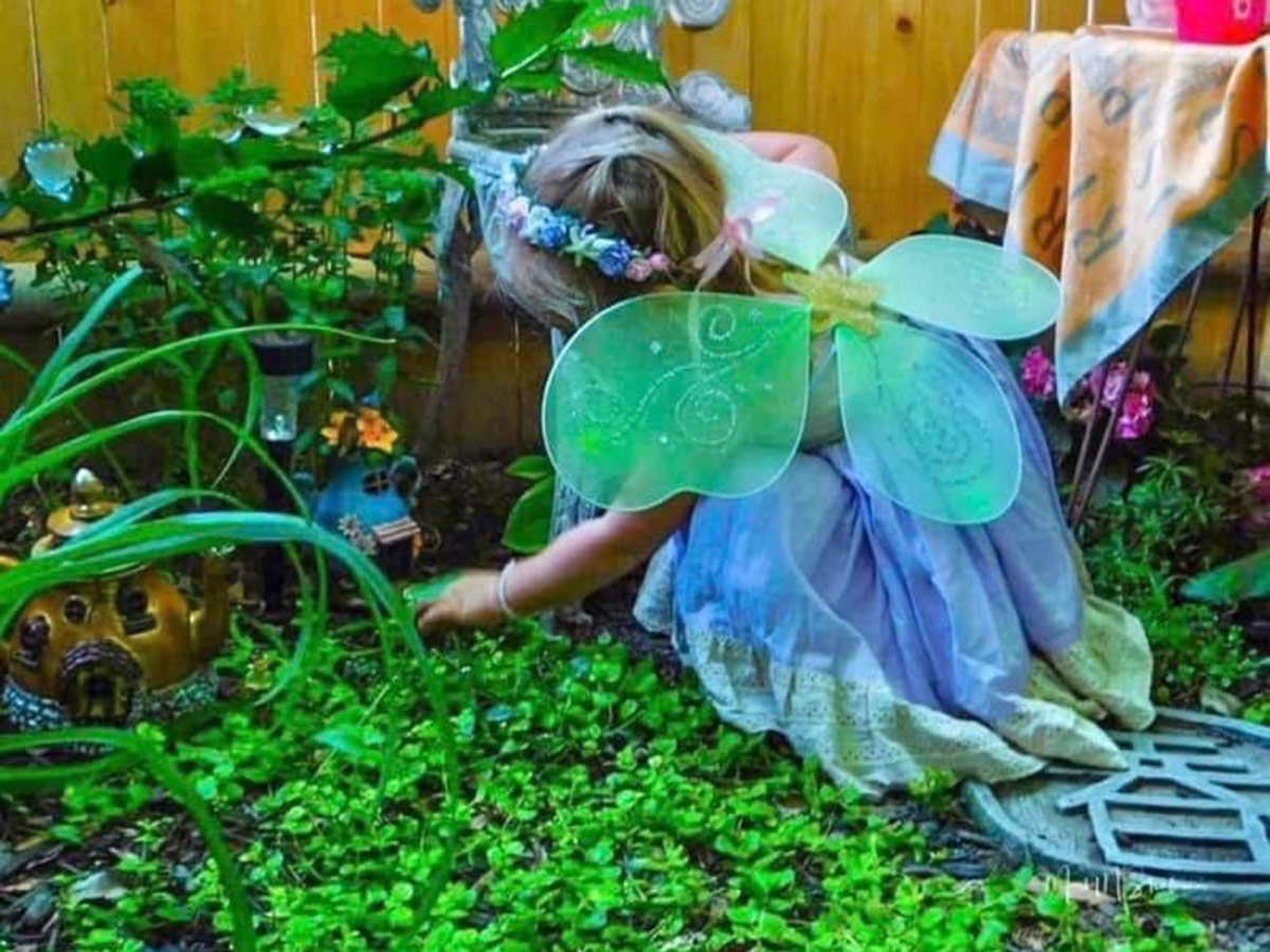 child playing in garden