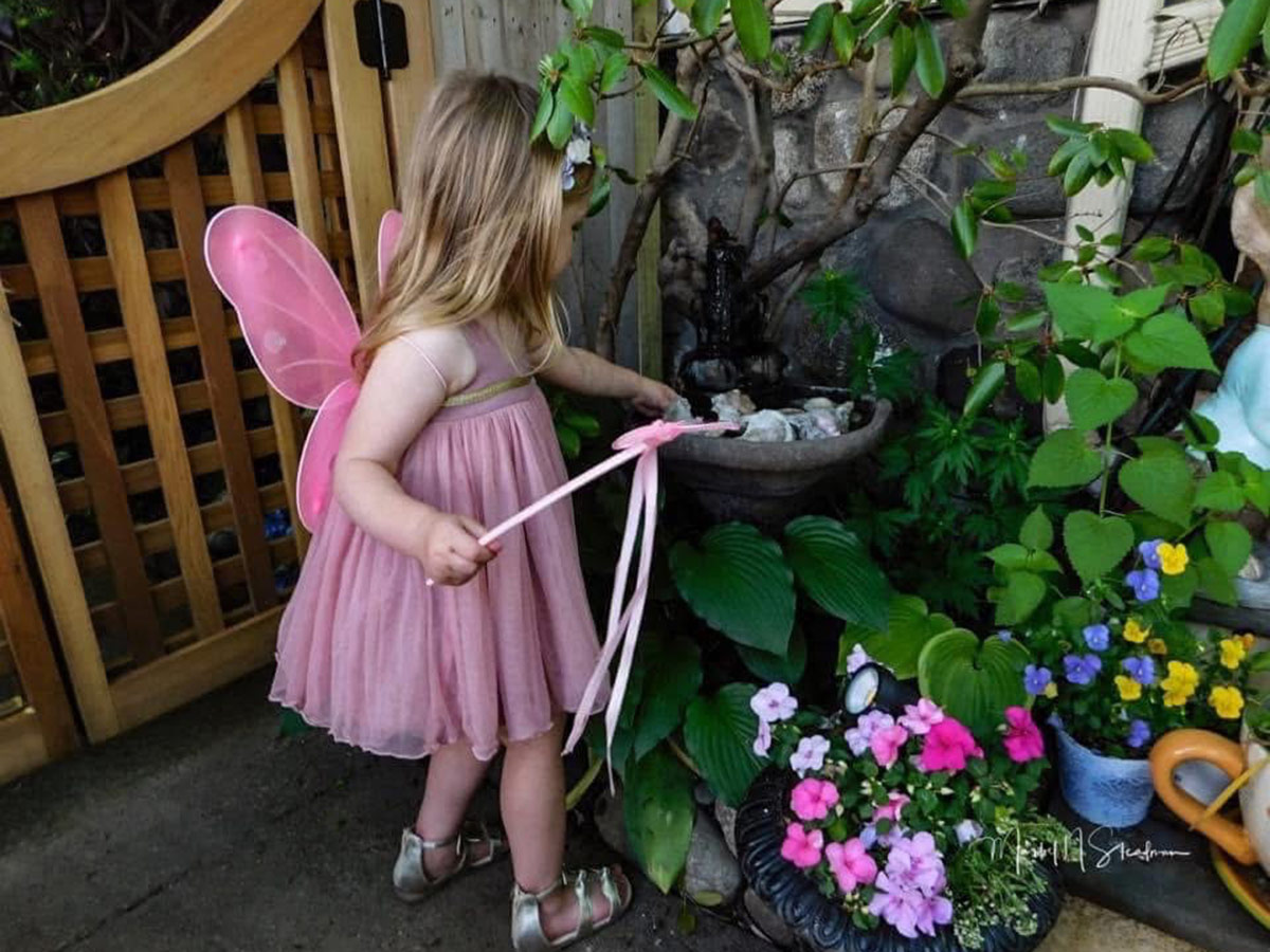 child playing in garden