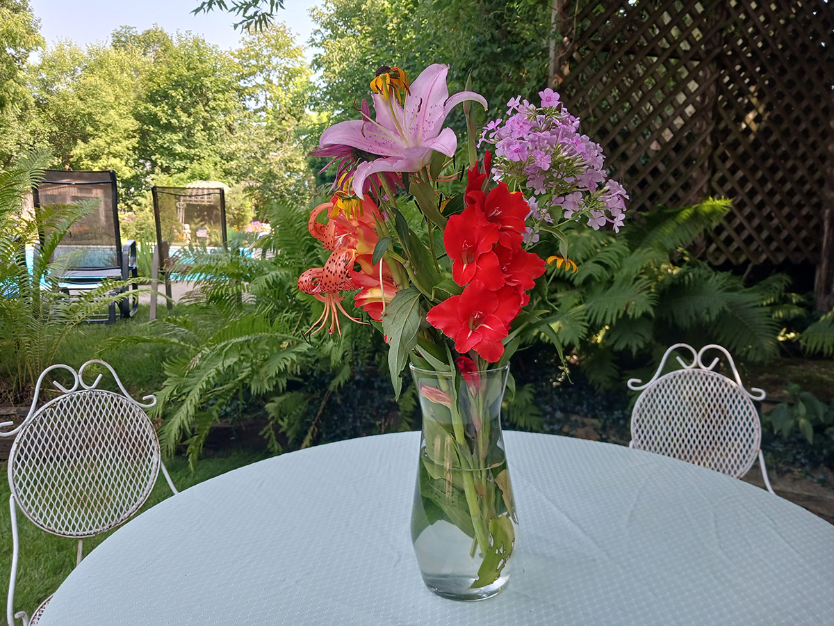 vase of colorful flowers on outdoor table