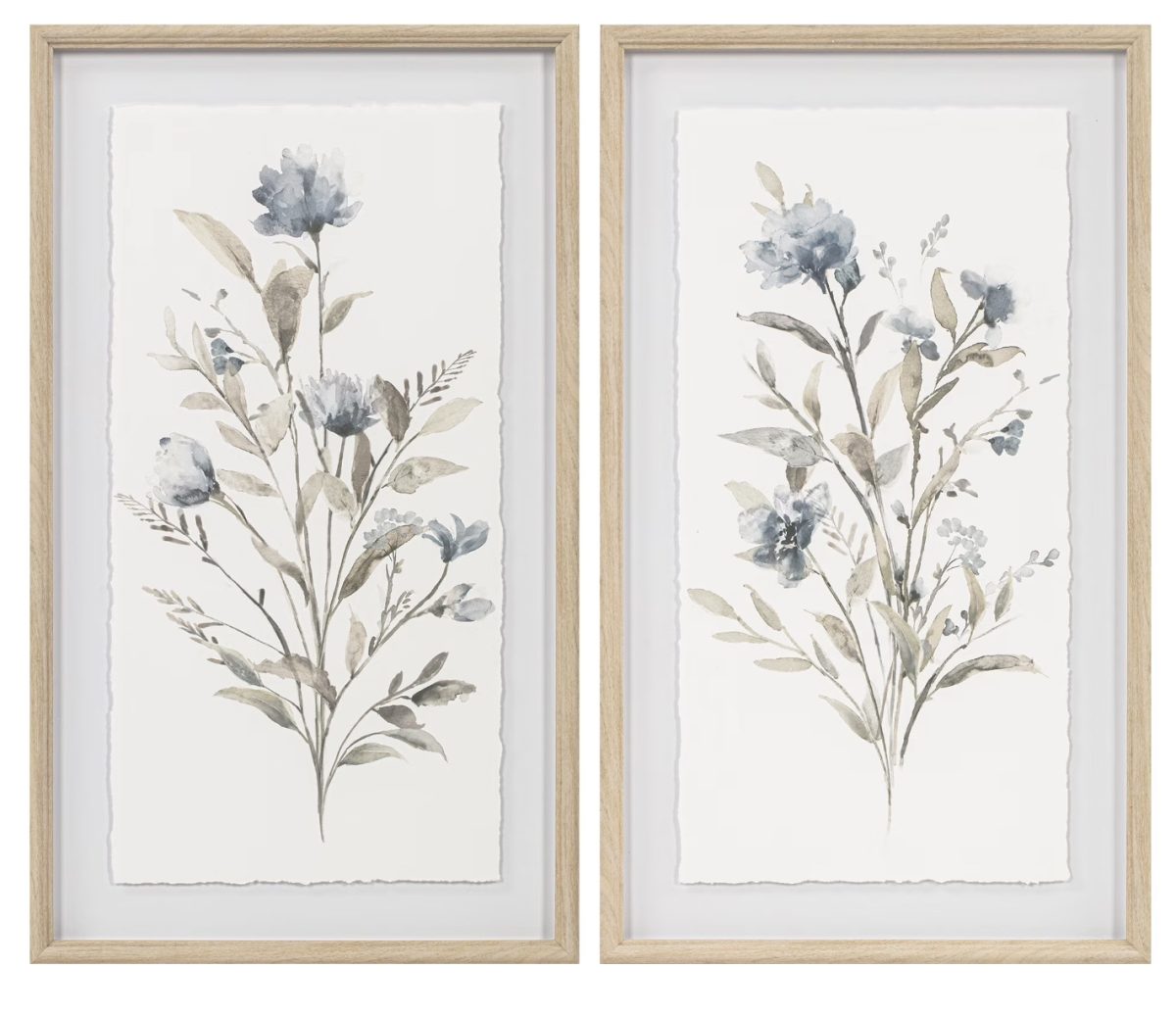 two framed botanical art prints featuring watercolor-style illustrations of blue and beige flowers with leaves, set against a white background and surrounded by light wooden frames.