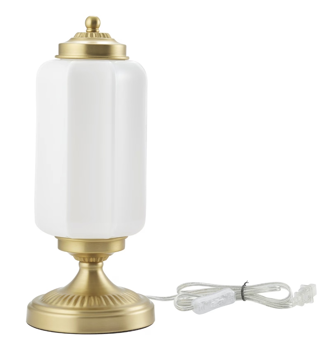a table lamp with a gold base and a tall, cylindrical white glass shade. a clear electrical cord with a switch is visible, coiled beside the lamp. the lamp has a vintage, elegant design.