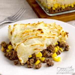 pâté chinois recipe (french-canadian shepherd’s pie) 3 pâté chinois served on a white plate with layers of ground beef, corn, and golden mashed potatoes.