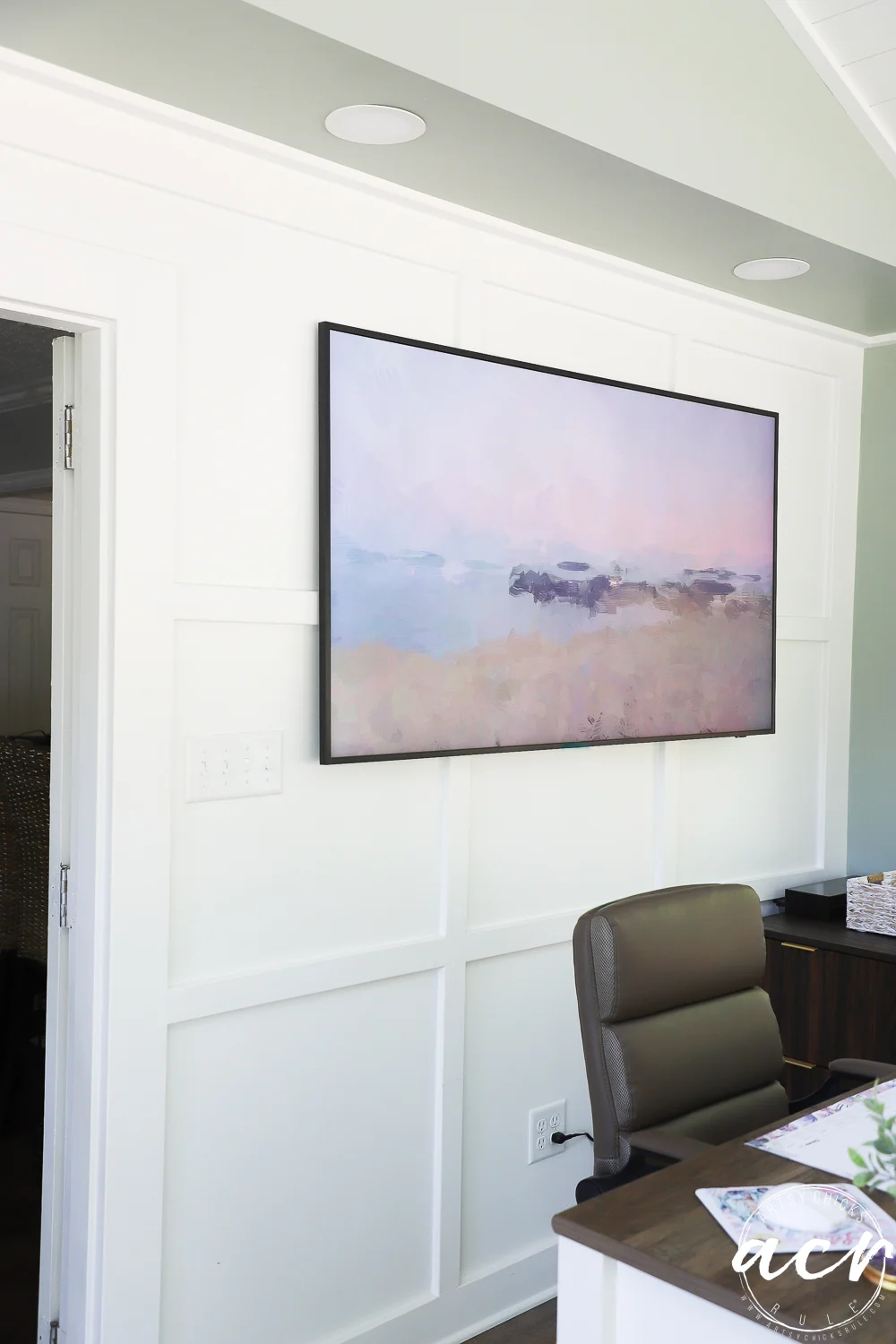 office reveal (sunroom) - artsy chicks rule® 76 a modern office area with a brown chair, wooden desk, and a large abstract landscape painting in soft pastel colors hanging on a white paneled wall—perfect for an inspiring office reveal.