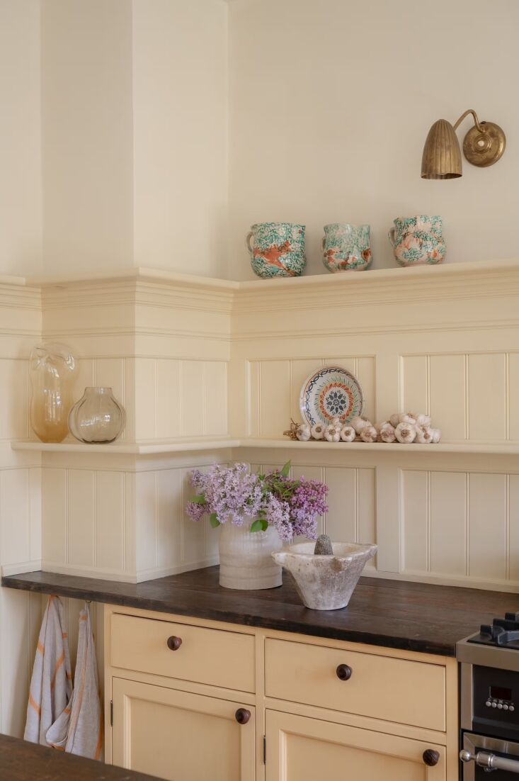 open shelving holds a collection of antique sicilian splatterware. the wall lig 22