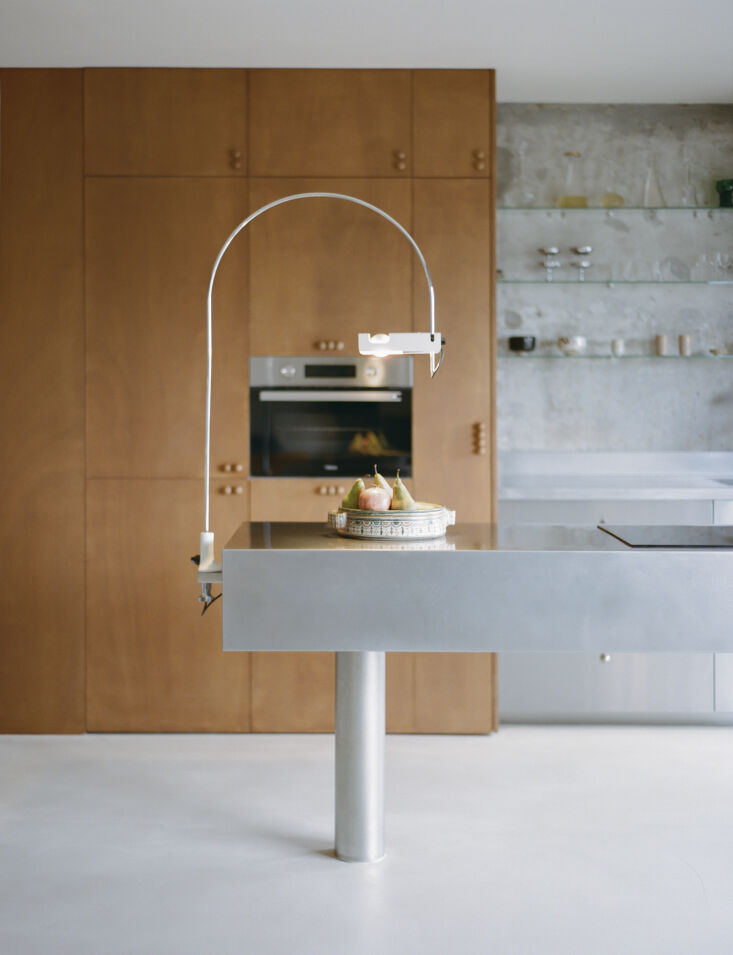 the lamp is a joe colombo spider arc lamp from 1967. the cabinets are okoumé  19