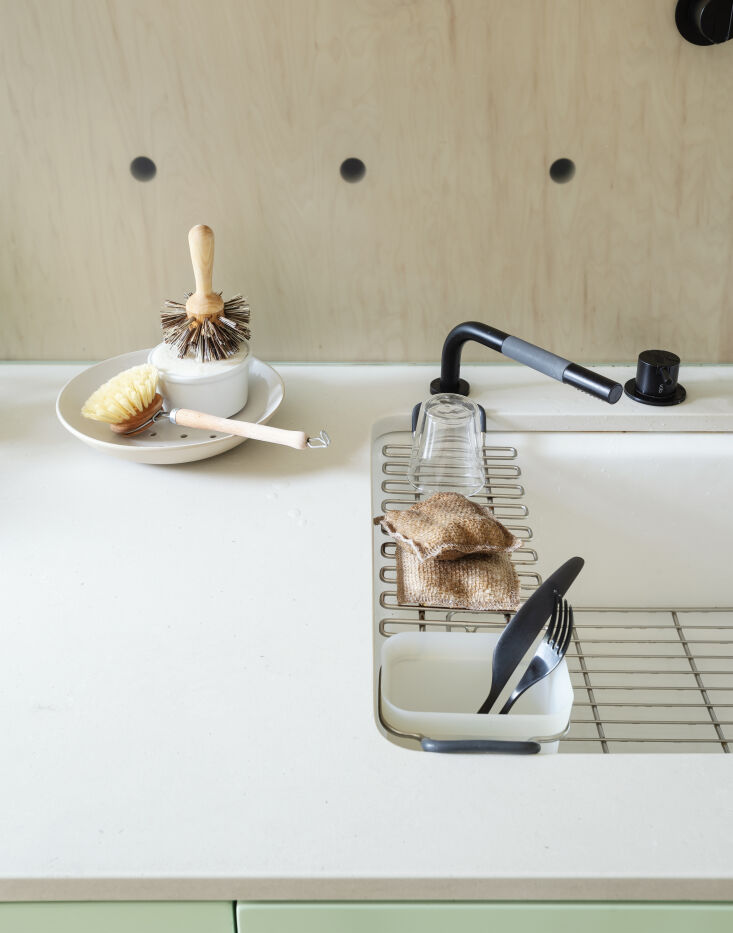 a detail of the kitchen sink showcases a few eco swaps including a low flow fau 18