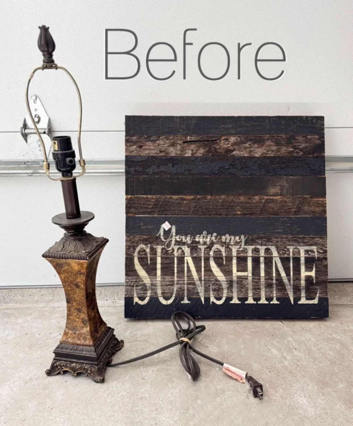 a vintage lamp without a shade and a wooden sign that says “you are my sunshine” sit side by side on thrift shop concrete floors. the word before is written above them in large text.