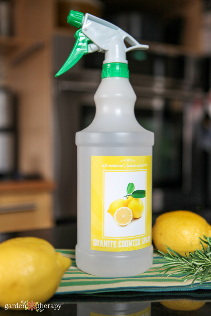 diy granite cleaner with lemon and rosemary on a countertop