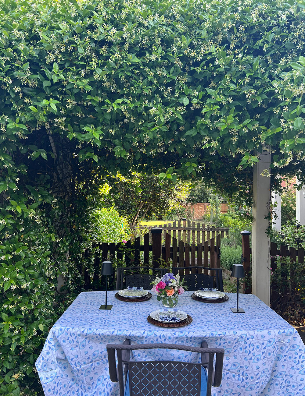 dining table under vine-covered pergola