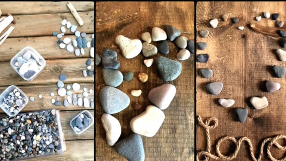 heart-shaped pebble art made with beach stones arranged on rustic wood